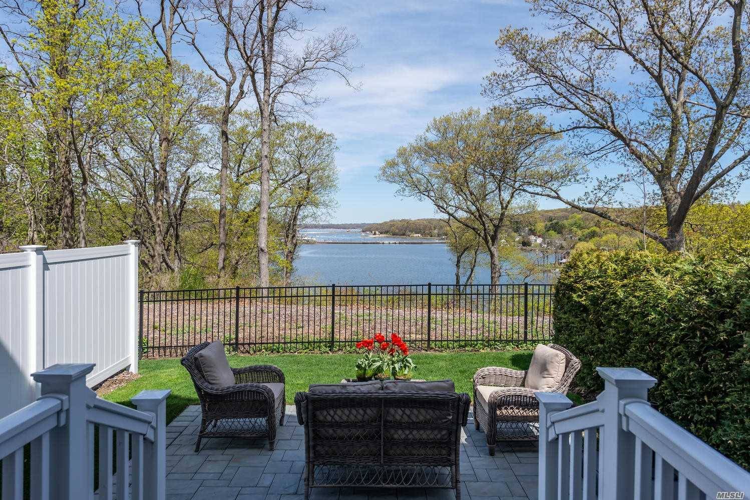 Open the door to Paradise in the barely two year old townhome overlooking Centerport Harbor.