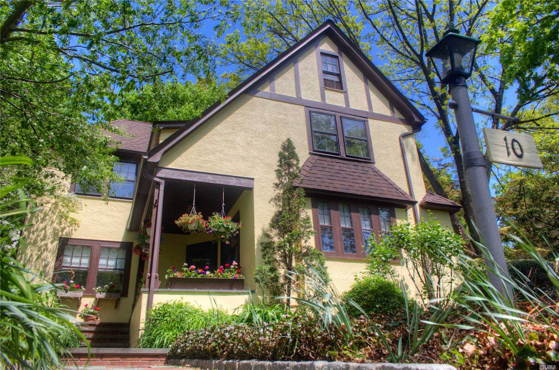 This enchanting tudor with storybook charm sits perched on the hills of Manhasset Bay Estates.