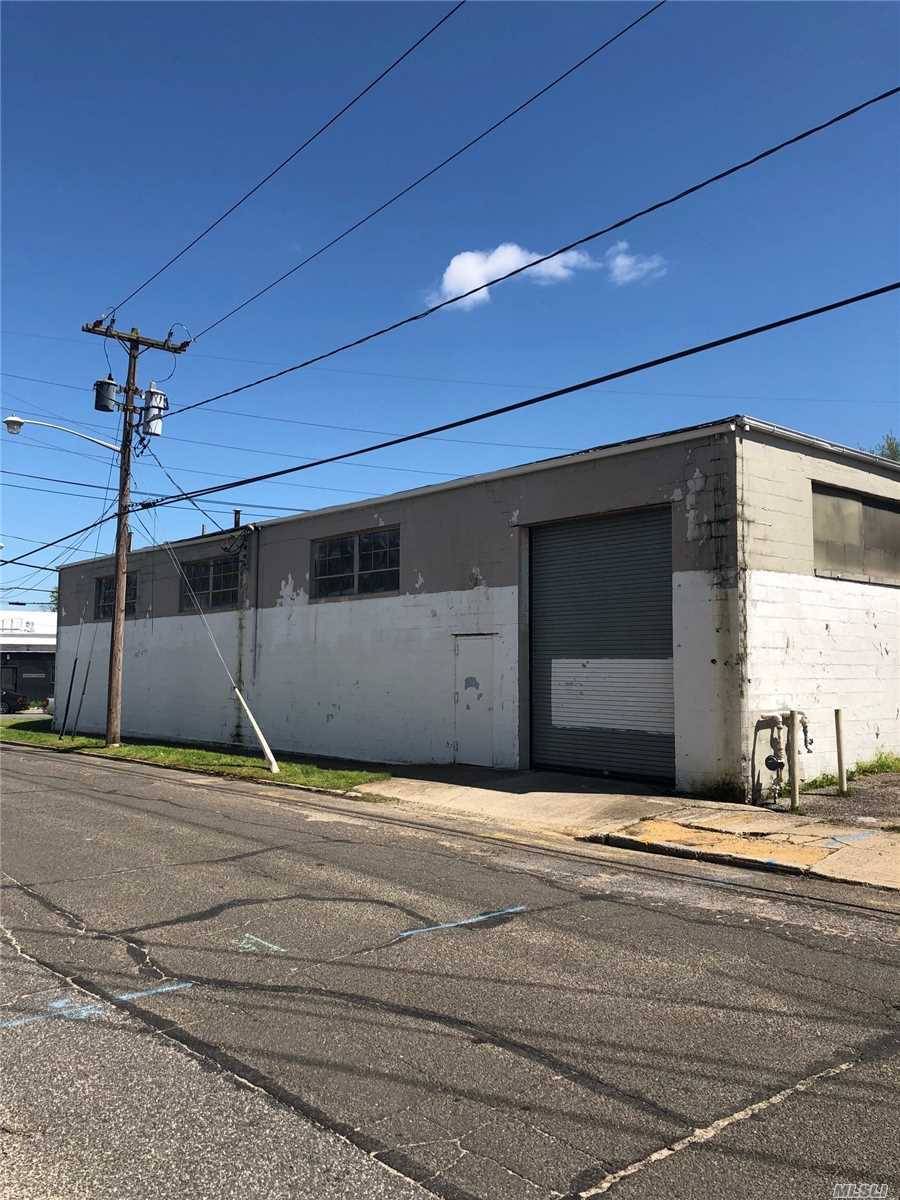 Corner L shaped warehouse, 2 overhead doors, 16 ft ceilings, small office and Mezzanine, 1 loading dock, 2 blocks from LIRR Sunrise Hgwy, 800 amp electric