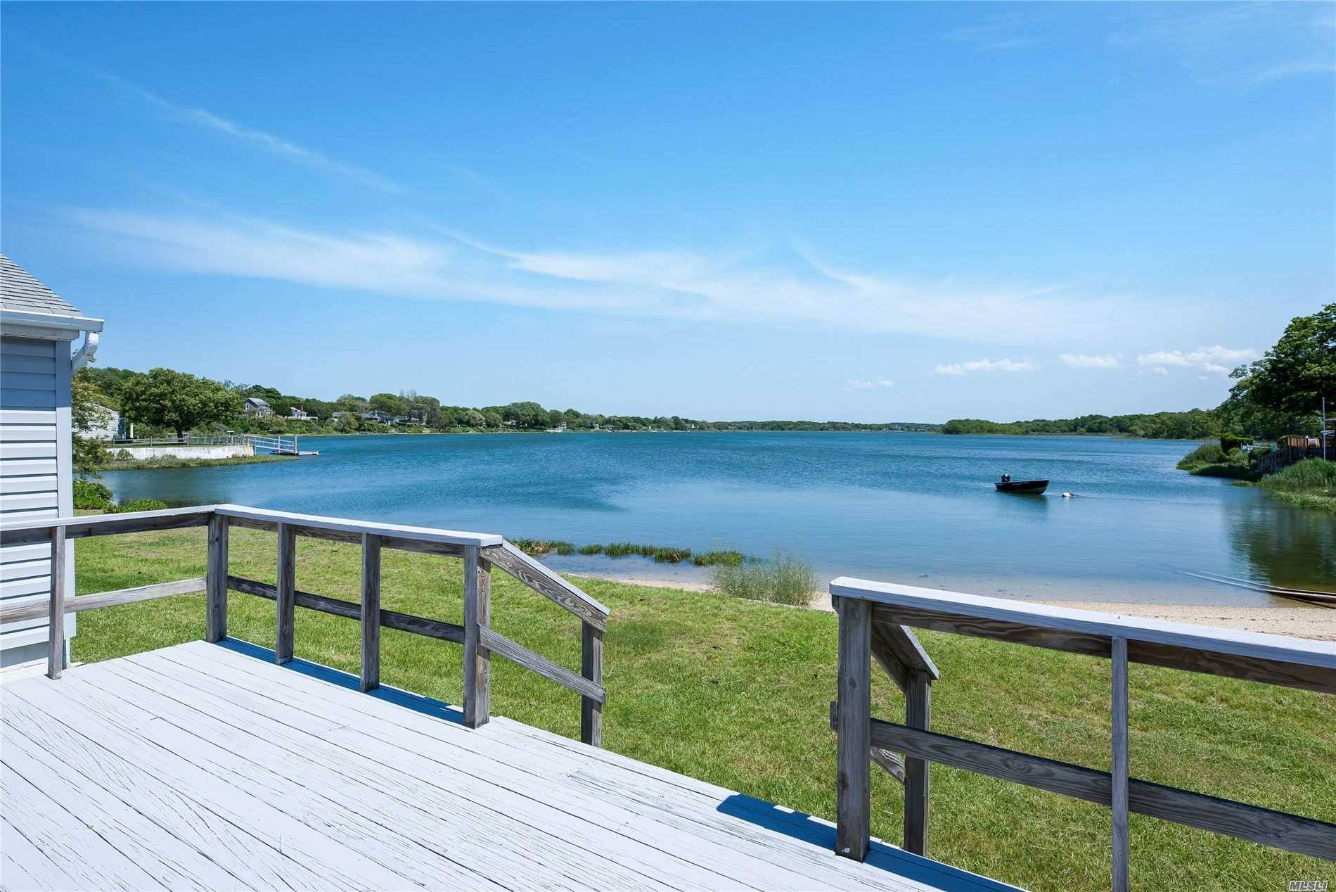 Water front ranch with forever views and 105 feet of private sandy beach on Hashamomuck.