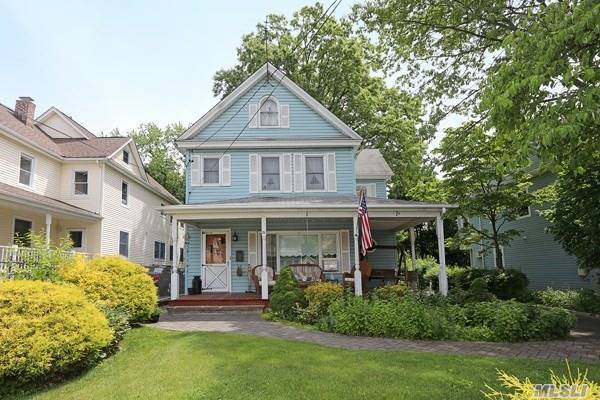 Charming 7 room Colonial in Port Washington features Eat in Kitchen w Stainless Steel appliances, Formal Dining Room, Formal Living Room and Basement with fireplace plus Laundry.