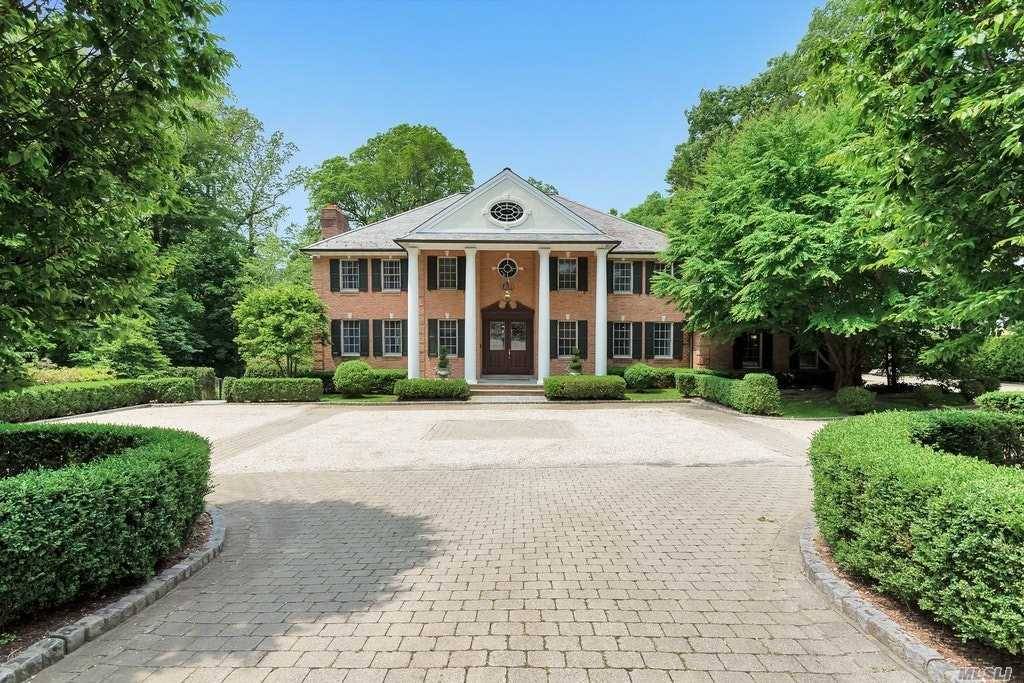 Classic Elegant 5 bedroom Brick Center Hall Colonial offering over 5400 sq ft of luxury on 1 acre in Flower Hill begins at the stunning grand marble Foyer.