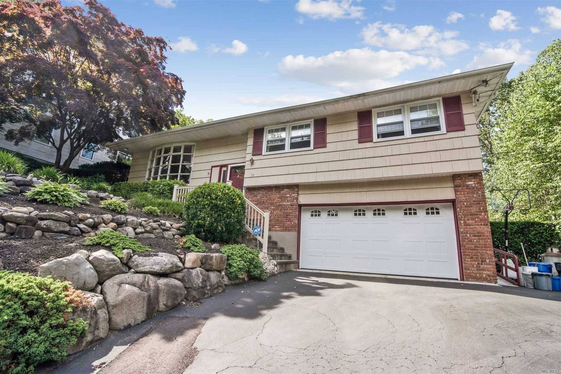 Beautifully landscaped, nestled on the hillside of this quiet tree lined street.