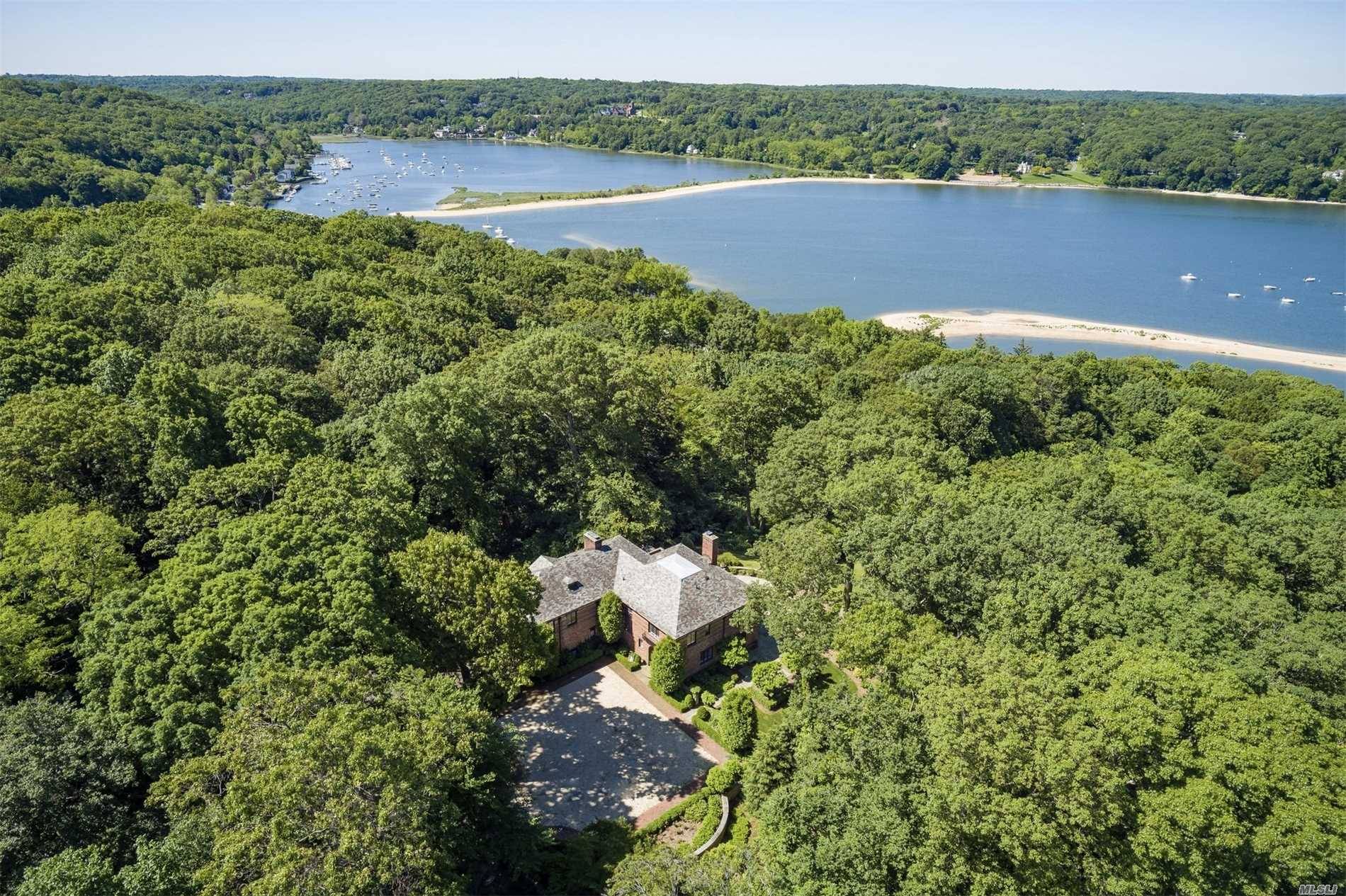 A Stately 16 Room Retreat just an hour from Manhattan with Waterviews over Cold Spring Harbor surrounded by a Lush 2 Acres at end of Private Road.