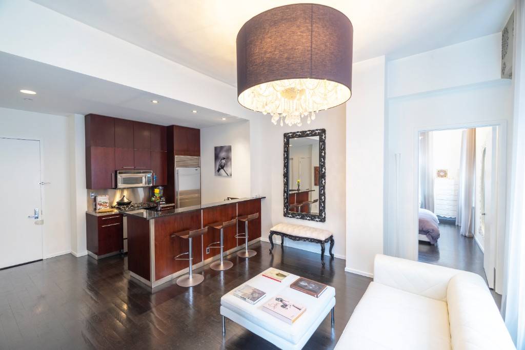 Beautifully decorated turn key condominium with 11 foot ceilings and oversized triple exposure windows North, East and South that make this a surprisingly bright and peaceful apartment.