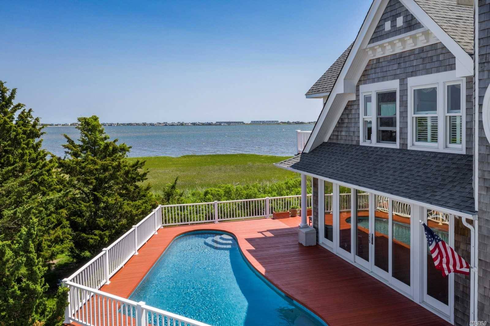 On 4 waterfront acres and 292 ft of frontage on Moriches Bay, this 4 bedroom, 4.