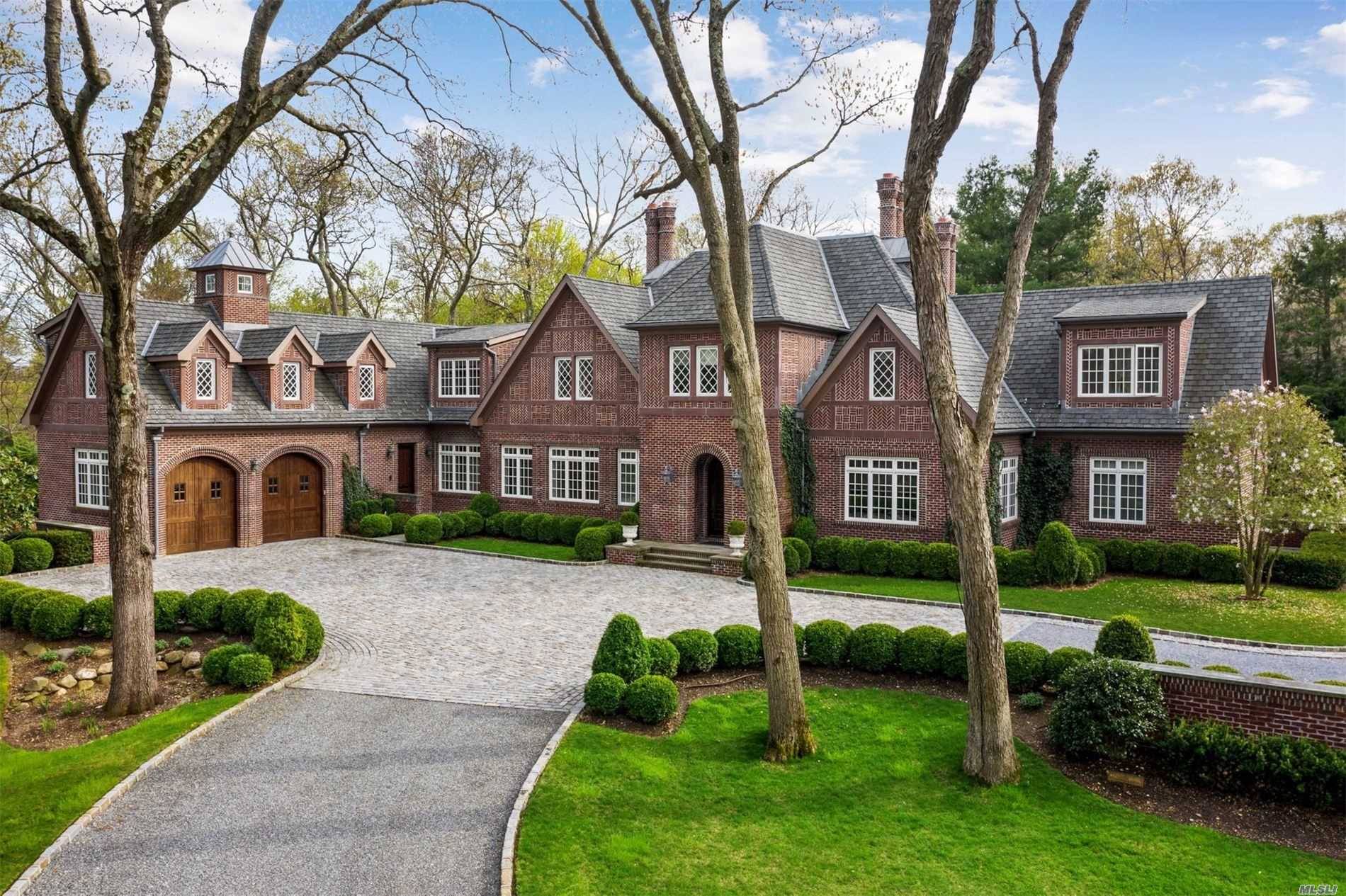 Absolutely stunning and unique 7500 sq ft stately brick tudor style home on 2 lush, private acres with 1, 000 sq ft Studio Pool House w Fp, Kit, Bth and ...