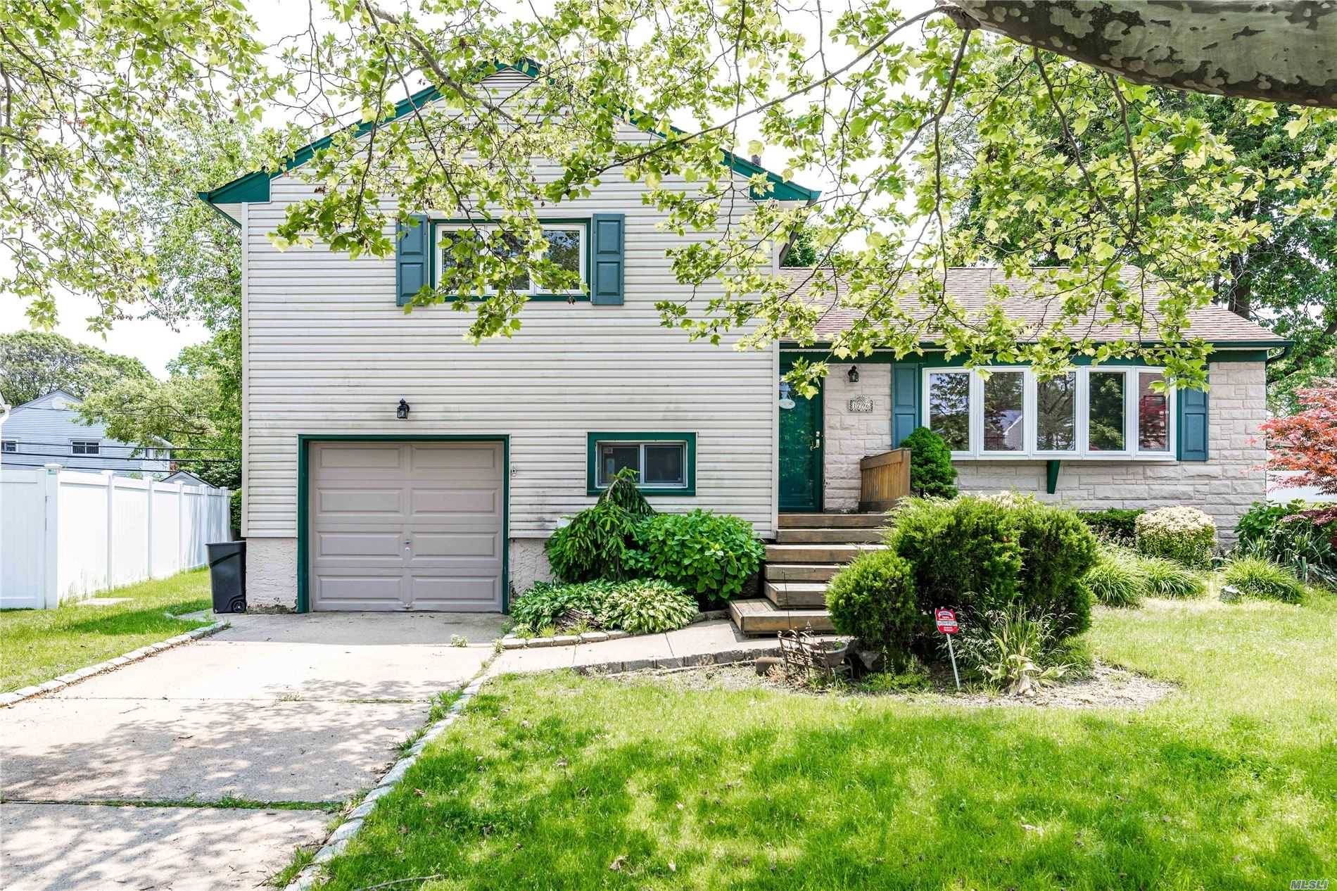 Step inside this huge 4 bedroom, 3 full bath split level home in the heart of East Meadow !