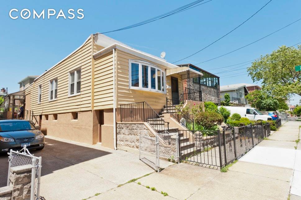 Single family detached house in Astoria Heights with a private backyard garden and parking for several vehicles.