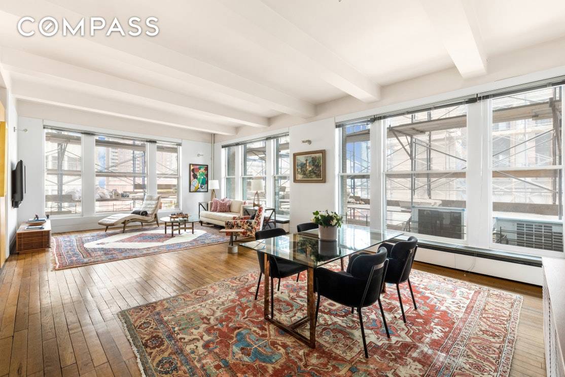 Residence 9E at 100 Hudson Street is a large, renovated, prewar one bedroom loft with lovely northern and western open city views in the heart of prime Tribeca.