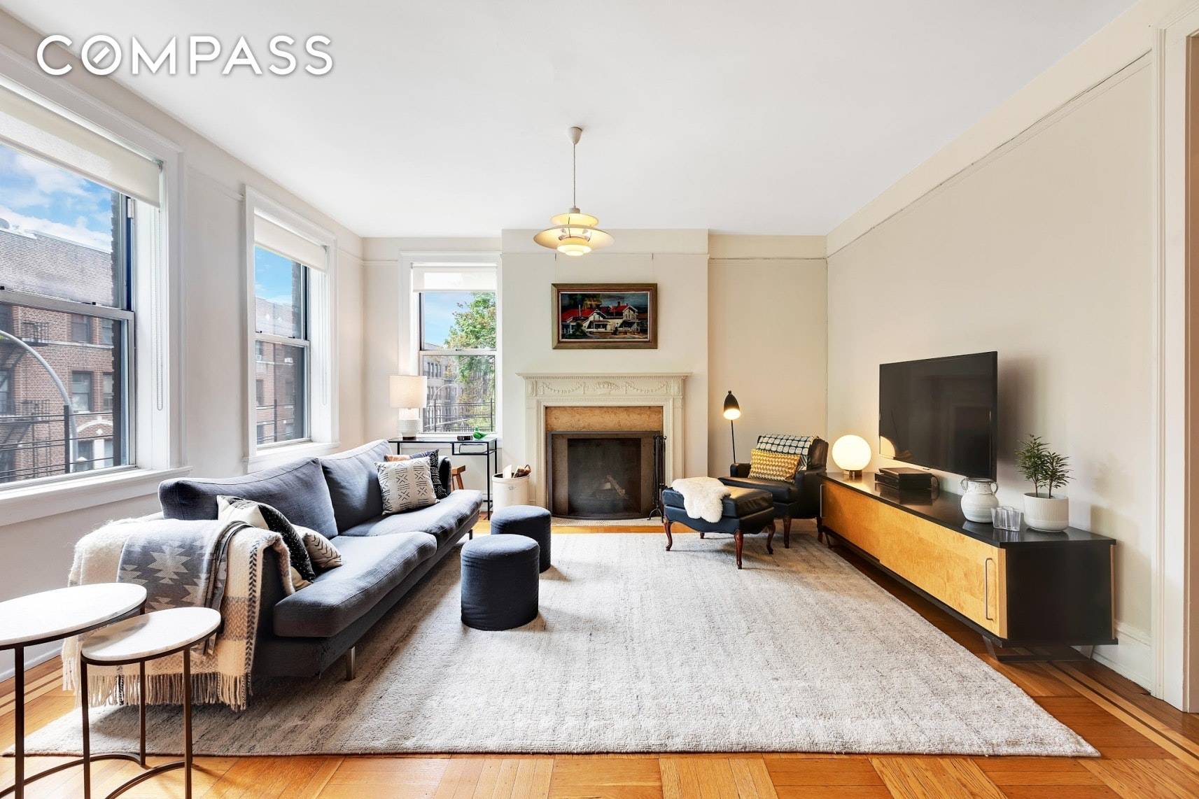 Space and light permeates this renovated, landmarked pre war five room co op with a fireplace in the much sought after historic district of Jackson Heights.