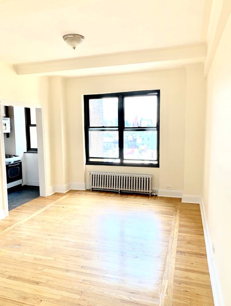 Bright East Village Studio Apartment For Rent Within Close Proximity of Astor Pl Station With Freedom Tower City Views Featuring Doorman and Laundry In Building