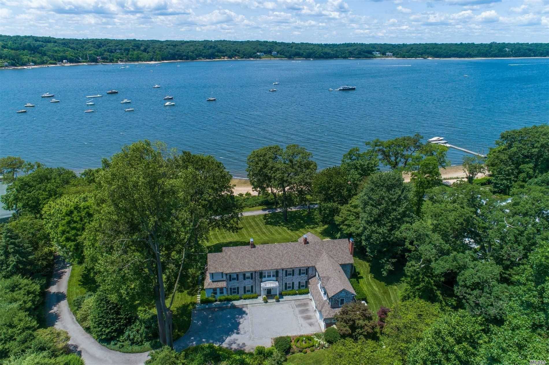 Exquisite Waterfront Residence with 333 feet of incredible beach and Unobstructed western Water Views.