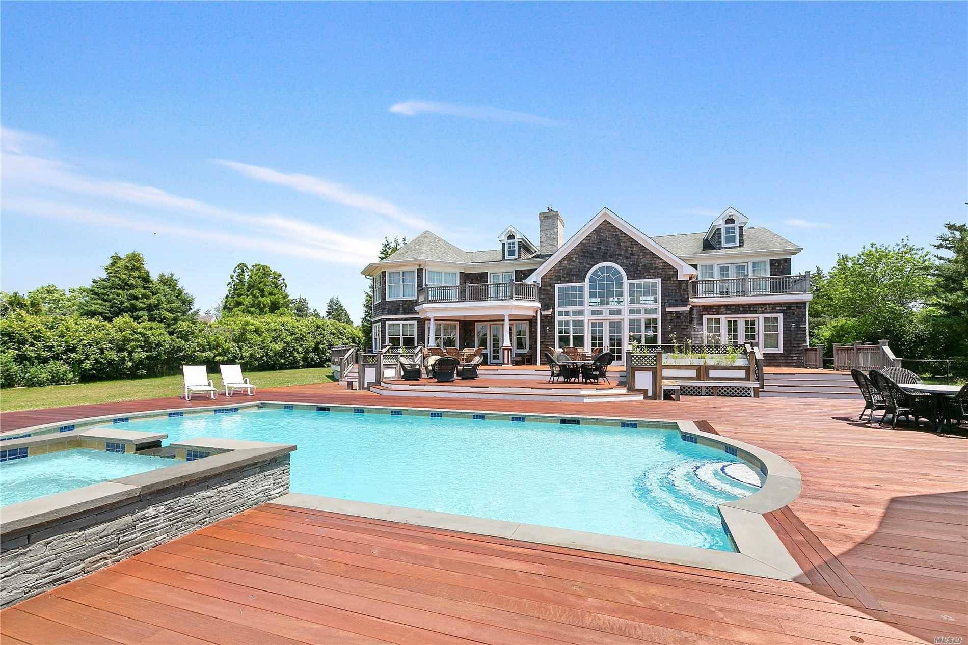NEW Exclusive ! 5 Pine Tree Lane, an expansive 8000 sq ft waterfront home with dock, pool and pool house situated on 1.