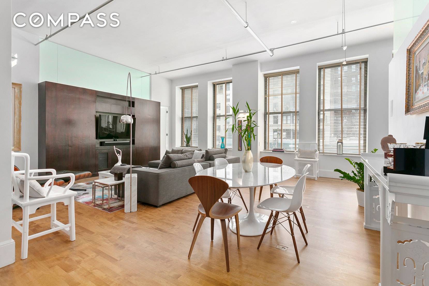 Distinguished by soaring 12' ceilings, and lined by 10 stunning double height windows, this modern yet classic loft is further graced by a renovation par excellence !