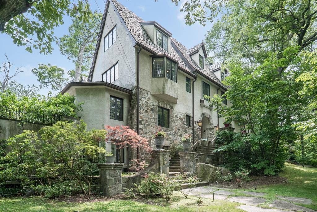 An architectural jewel Set on a hilltop defined by a lovely pond, this early 1900 stone, stucco TUDOR has expansive lawns, mature plantings, privacy and spaciousness.
