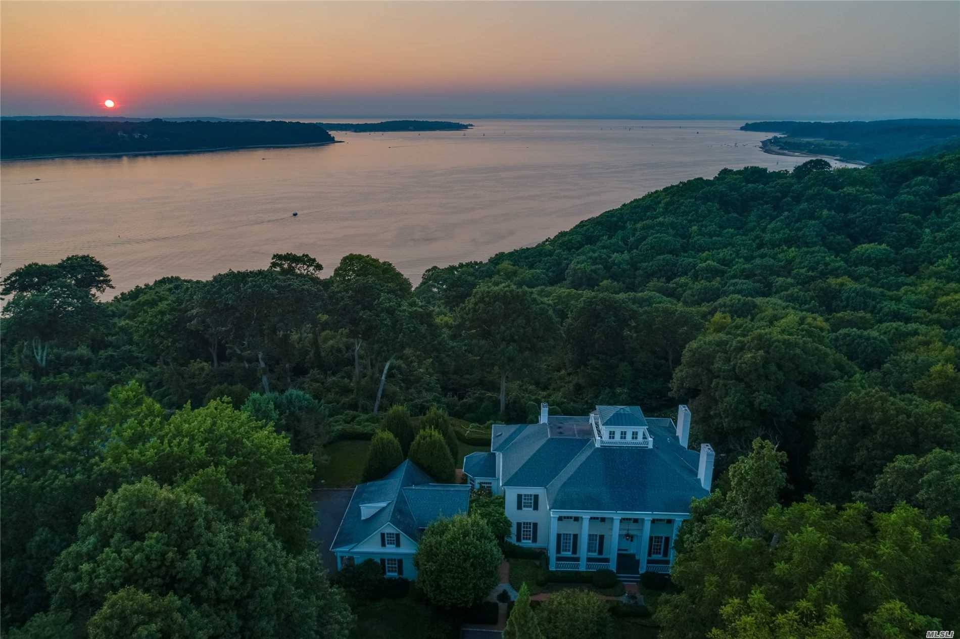 Waterfront Greek Revival architectural masterpiece overlooking Cold Spring Hrbr to Centre Islnd beyond w panoramic sunset views from most rms.