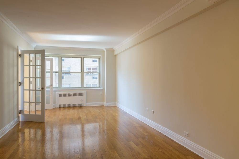 NO FEE! THIS SPACIOUS JUNIOR ONE BEDROOM/ALCOVE STUDIO WITH FRENCH DOORS FEATURES AN OPEN KITCHEN, GREAT LIGHT, AND LARGE CLOSETS.