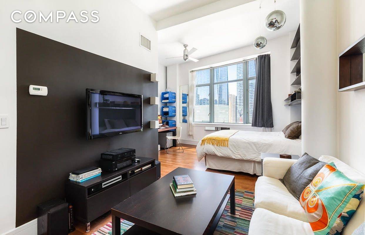FULLY FURNISHED loft like alcove studio with over 11' ceilings and three large windows with unobstructed, stunning, views of the World Trade Center !