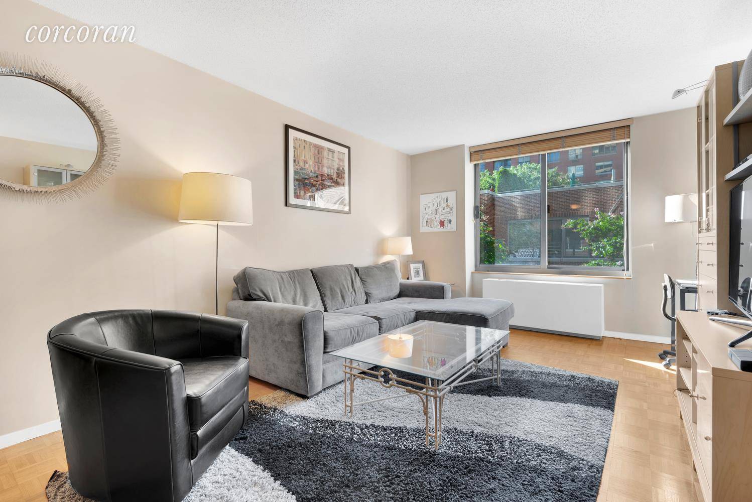 Welcome to this large one bedroom with serene views to the lush garden courtyard on a quiet cul de sac in Battery Park City !