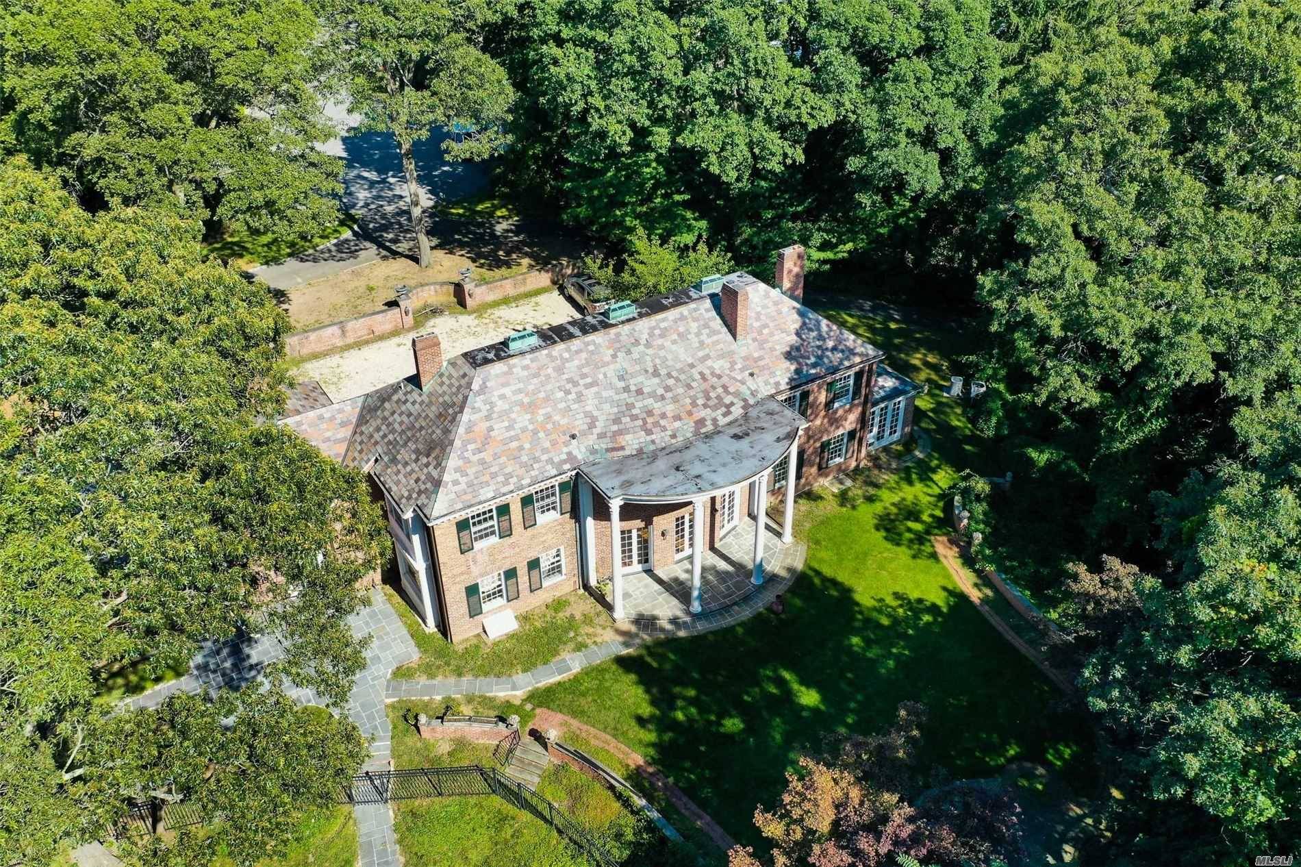 Majestic Brick Colonial Set On Over 2 Acres Of Lush Manicured Property Located In The Enclave Of Laurel Hollow Community.