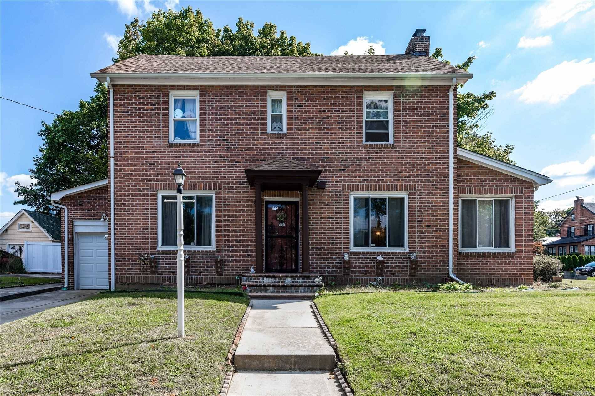 Spacious Brick Colonial with new roof, located on corner property featuring large windows in living and dining room.