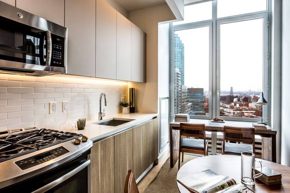 Modern studio apartment. Features a high-floor true alcove layout with breathtaking city and river views, floor to ceiling windows, condo-level finishes, w/d in unit, and ample closet space.