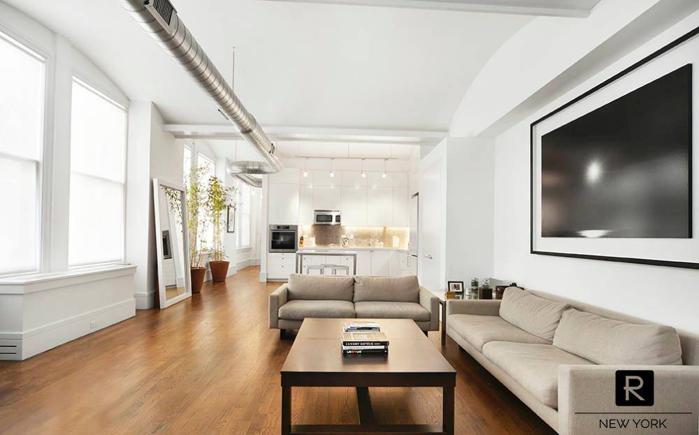 Step inside this sprawling 2, 400 square foot artist s loft with soaring 14 foot vaulted ceilings, custom LED soffit lighting, and original solid oak floors.