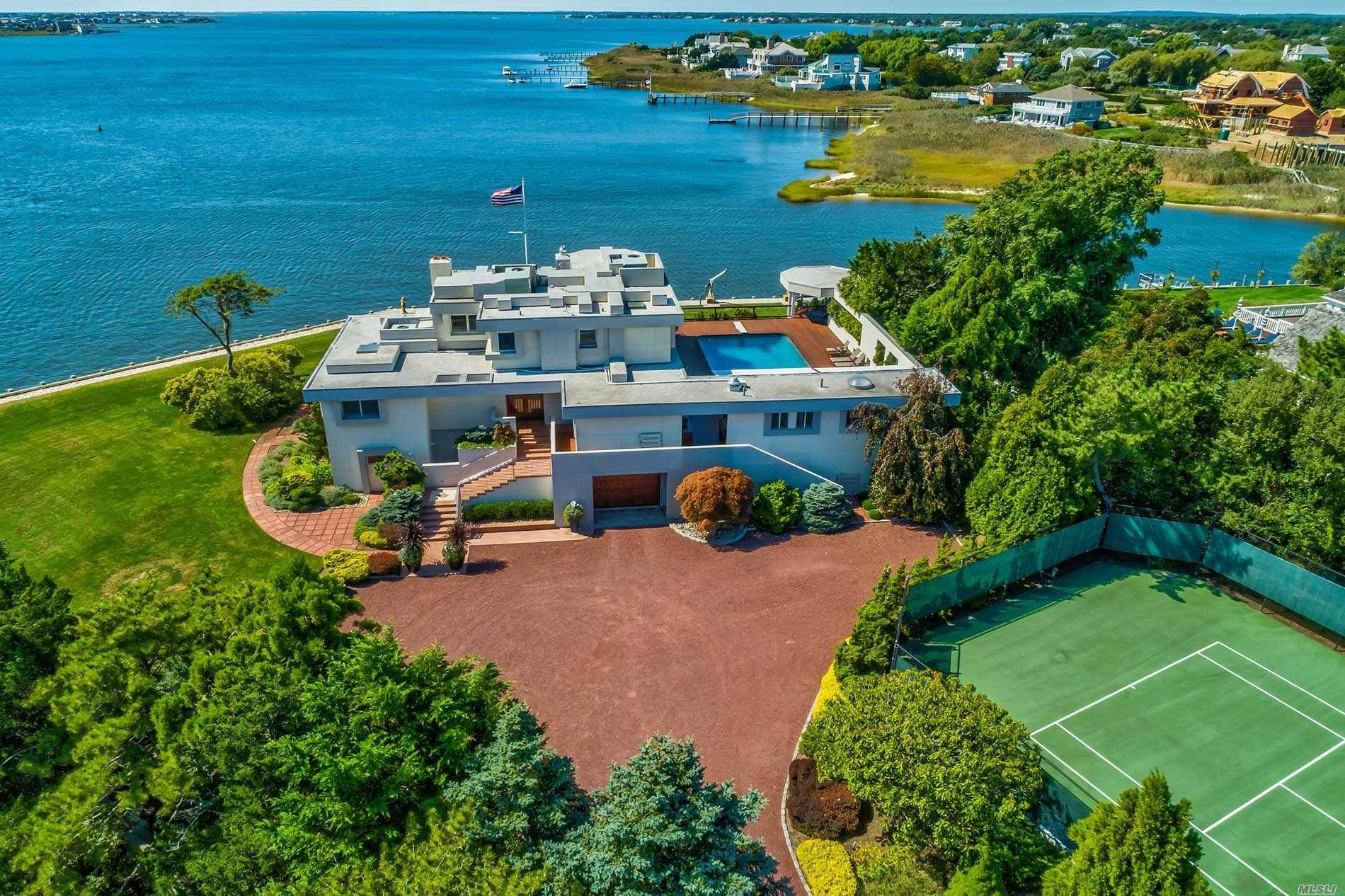 Set on 1. 31 acres sits a modern 5000sf waterfront home offering 6 bedrooms, 6 baths and meticulous mahogany and glass details throughout.