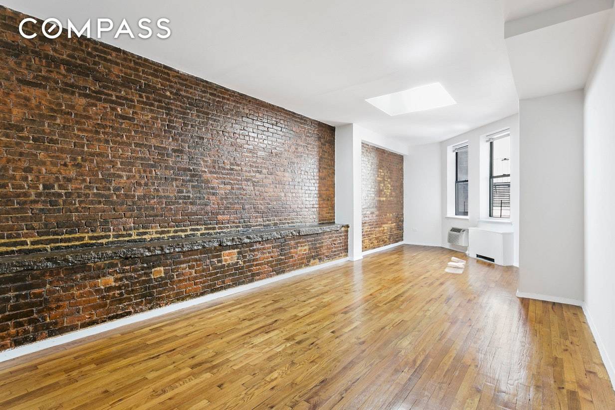 This unique and spacious studio features a HUGE walk in closet, a skylight, and exposed brick.