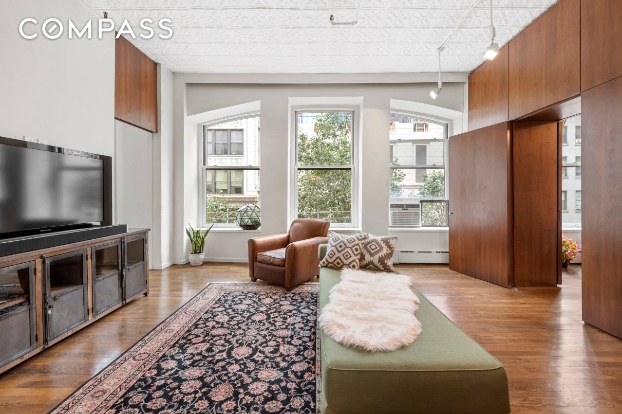 Featuring South sun and massive arched windows, this amazing two bedroom classic loft features an open floor plan, soaring 11 foot tin ceilings and cast iron columns.