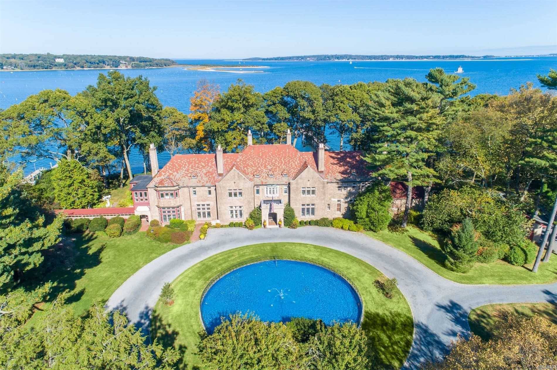 This historic water front estate is perfectly situated on 5 lush acres overlooking Lloyd Harbor.