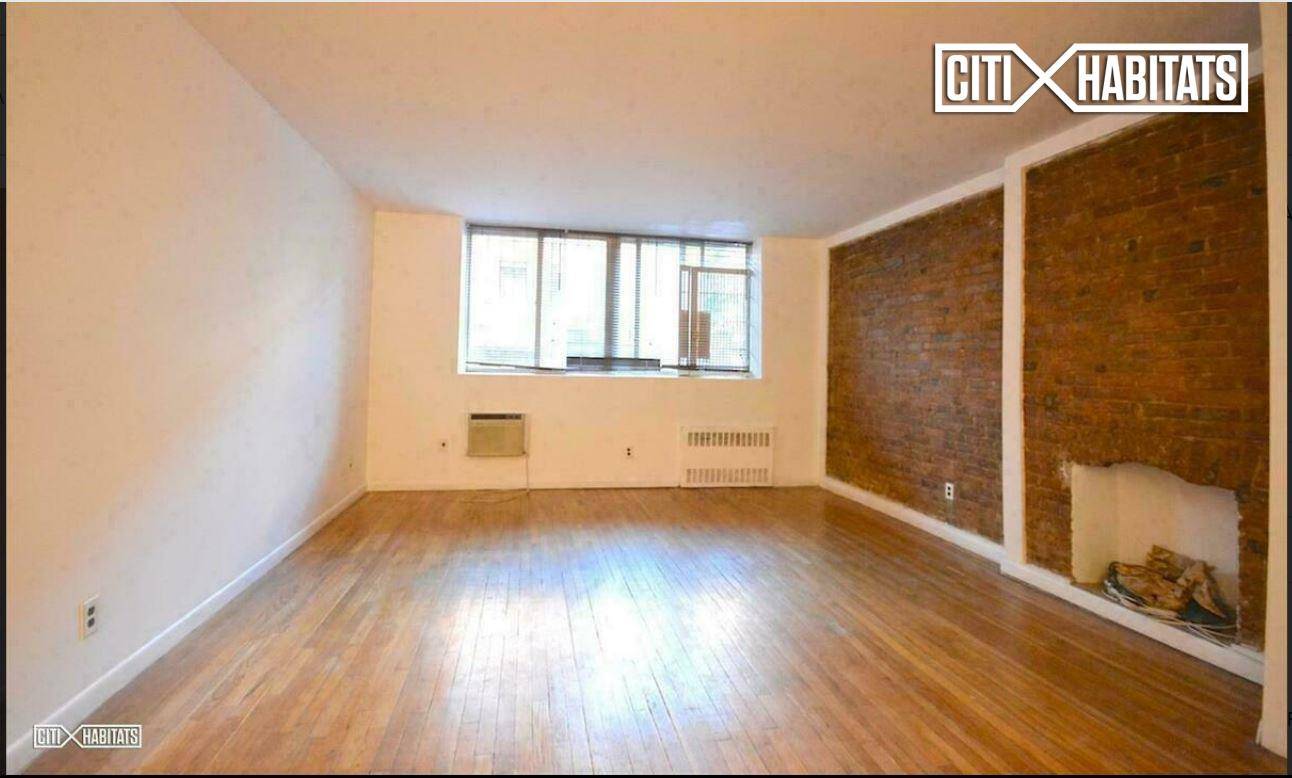 Classic prewar Brooklyn apartment with high ceilings, exposed brick, hardwood flooring and quaint decorative fireplace.