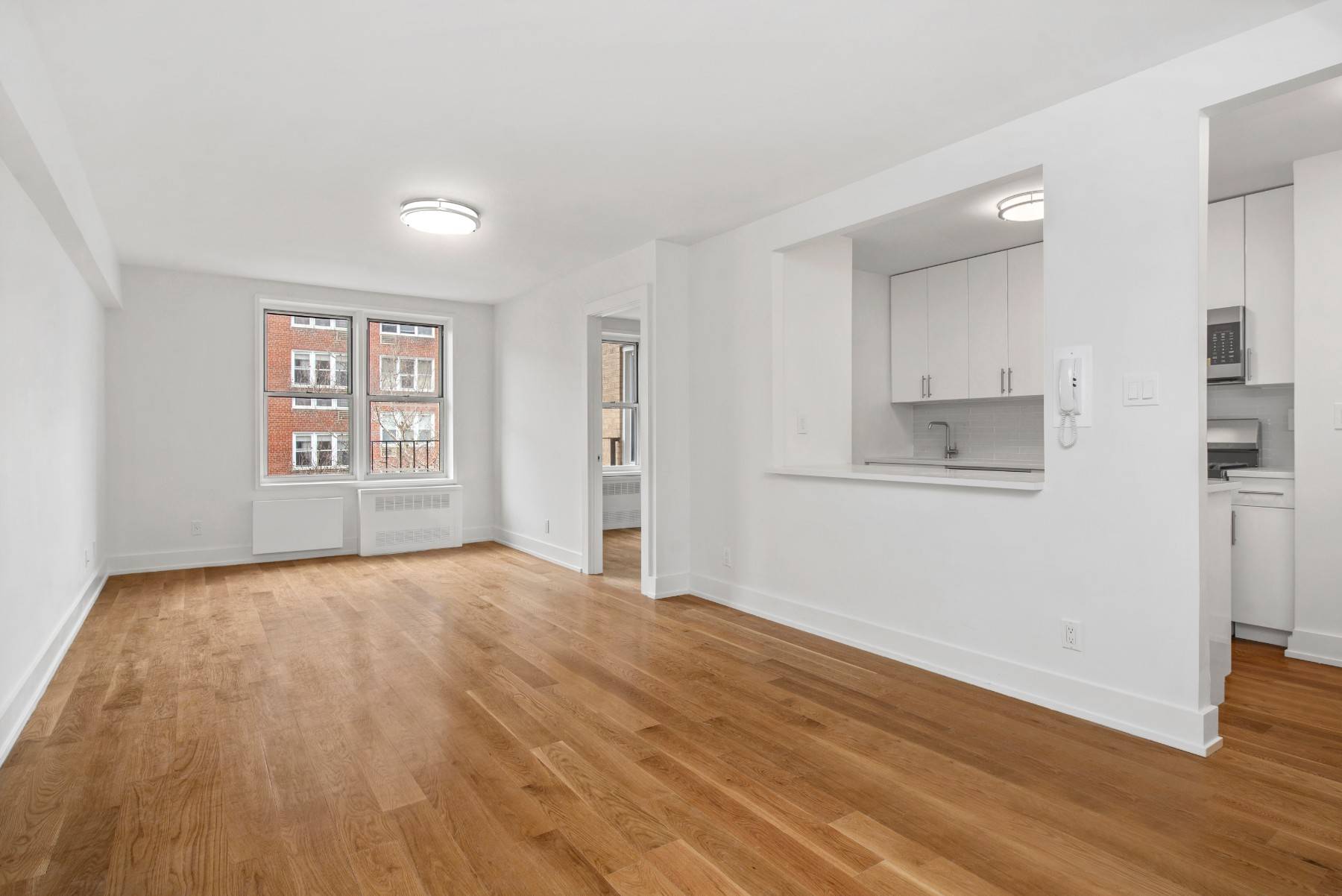 This modern, gut renovated two bedroom apartment features new oak hardwood floors, a spacious living room, separate kitchen with stainless steel appliances which include a microwave, stove, dishwasher, and refrigerator, ...
