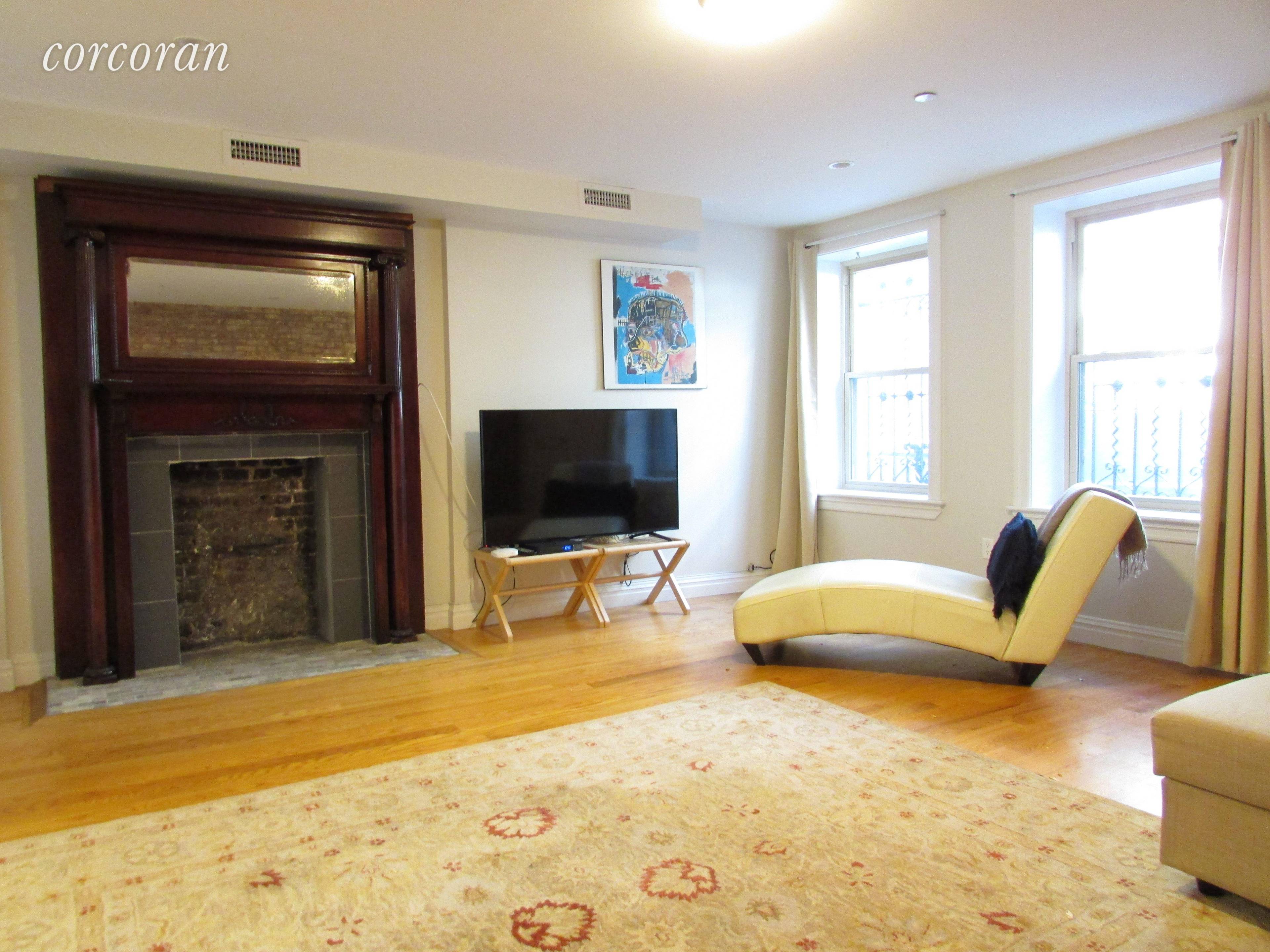 Spacious two bedroom with decorative fireplace, hardwood floors and over sized windows.