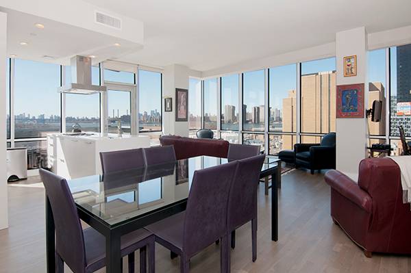 Take in the Views Through the Wall of Windows at This Fantastic SW Corner 2-BR in LIC w/Parking
