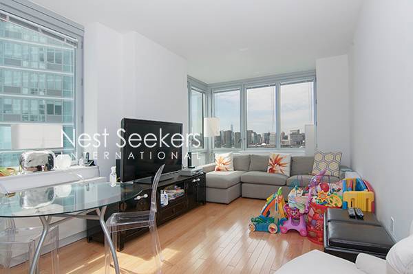 NO FEE! Stunning Water & City Views + Washer/Dryer + Balcony on Long Island City Waterfront