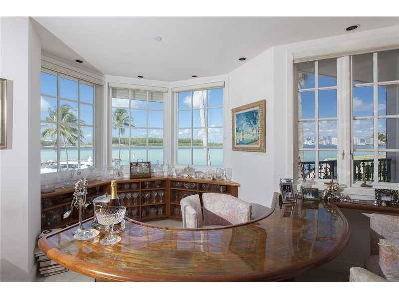This private second floor 3BR/3+1BA Bayside residence overlooks the Fisher Island Marina with beautiful views of Biscayne Bay