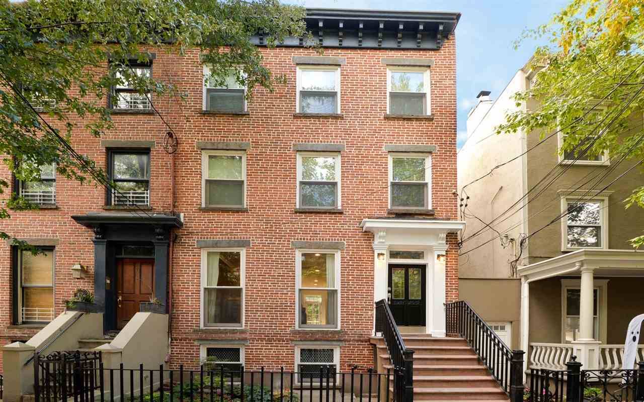 Magnificently finished semi-attached brick row house on a 20' x 75' lot (home is 20' x 30' deep)