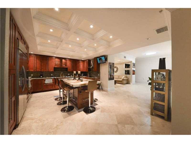 Stunning 3/3 + den corner penthouse in luxury Gables boutique complex has south