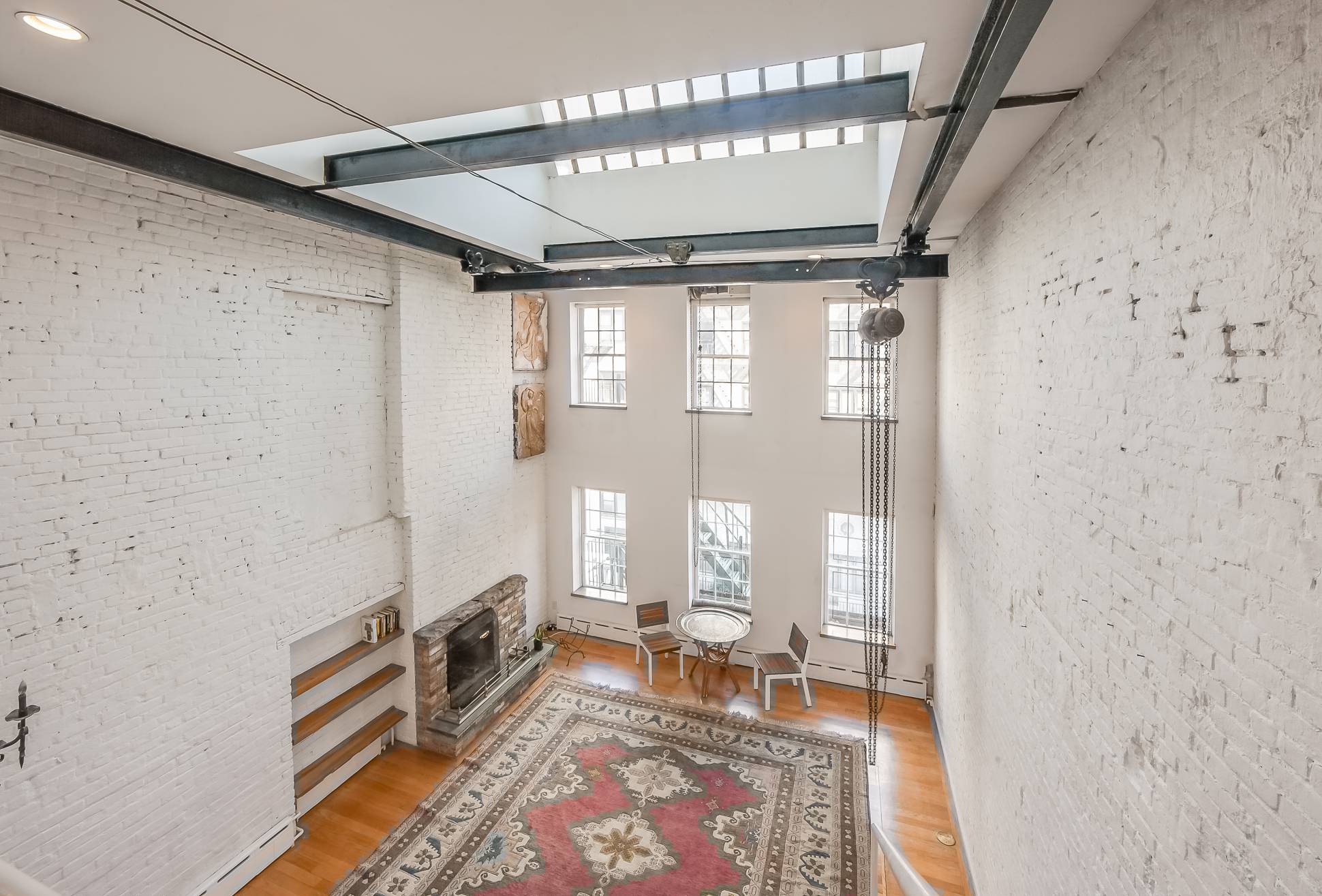 One of a kind Loft with 24' ceilings, wood burning fireplace & private terrace in a brownstone