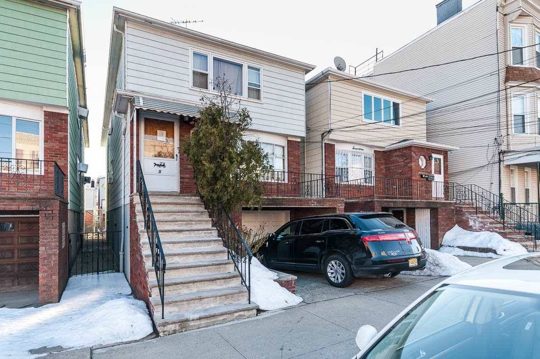 Beautifully kept young 2-Family with garage looks and feels like a 3-Family