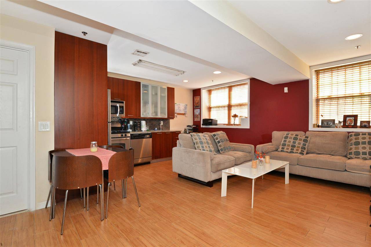 Spacious one bedroom with open kitchen and living room features private outdoor space