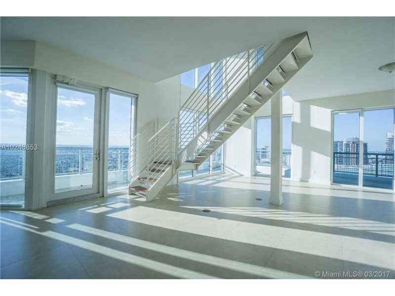 2 story loft style corner unit features high ceilings and expansive glass walls