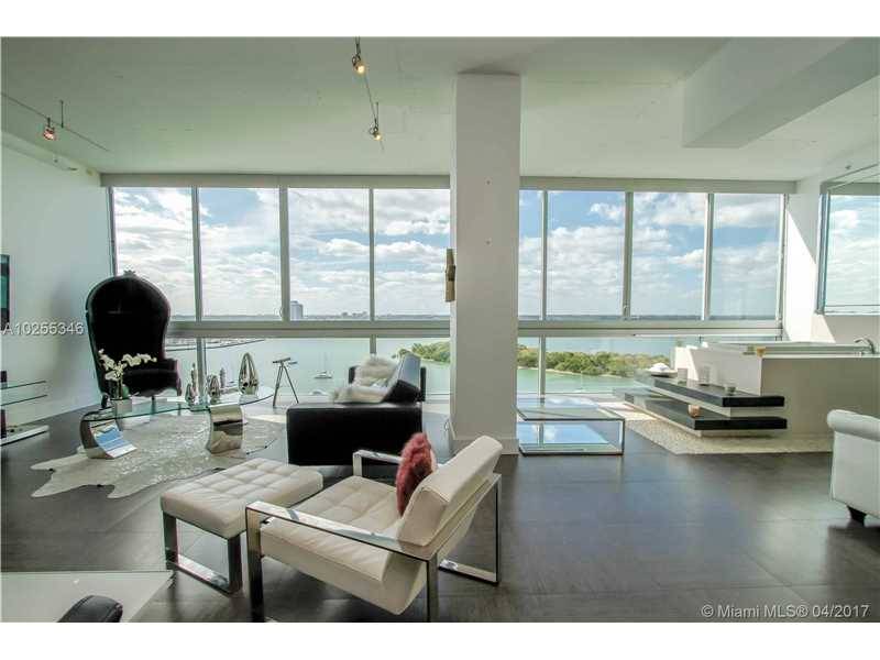 View Biscayne Bay & the entire Miami city skyline through a 35' long wall of glass