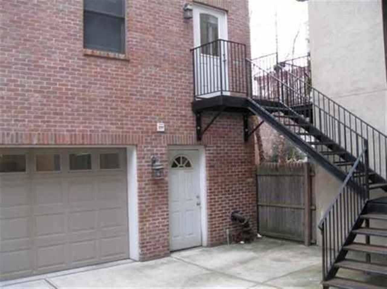 2br/1ba Carriage house with a roof deck and garage parking w/room for 2 smaller cars