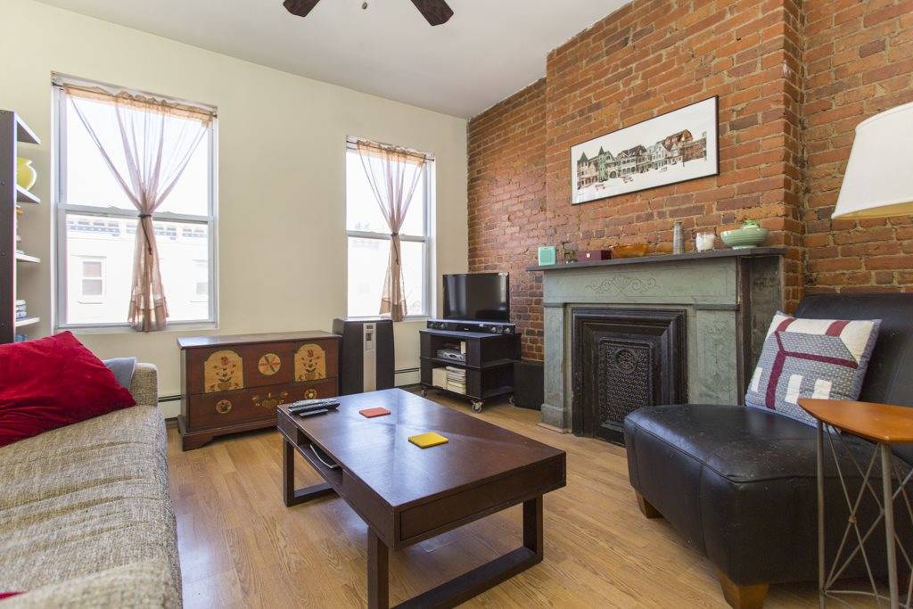 Beautiful exposed brick throughout this condo unit with a decorative fireplace that adds charm and detail