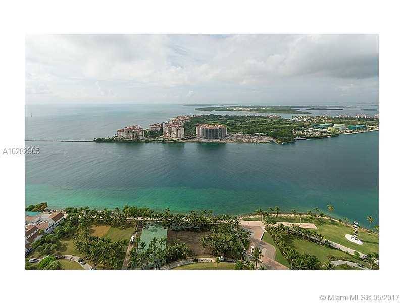 Amazing views of Ocean and Miami Skyline from this high floor flow-through 2 bedrooms plus den