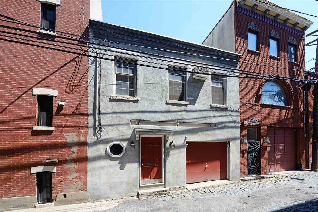 Rare opportunity to own a wide single family home with 1 car garage parking on Court Street: Hoboken's historic cobblestone street
