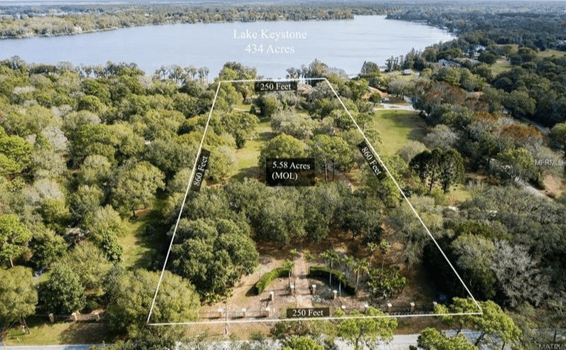 Florida Investors Dream. 250ft Lakefront footage and 5.5 total acres on Lake Keystone in Odessa Florida. Main home and separate mother-in-law building.